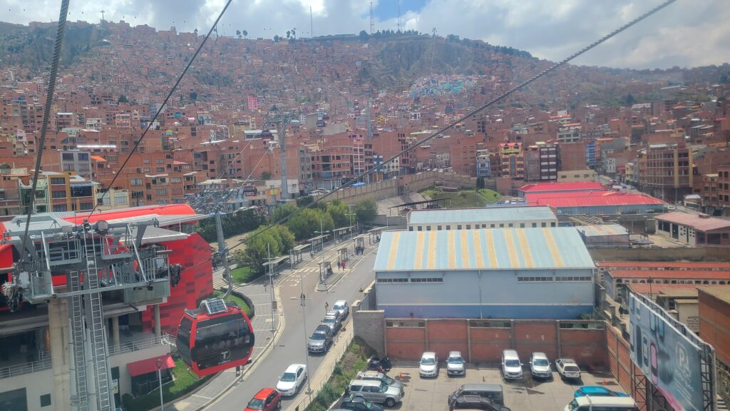 Colorful neighborhood in between the terracotta buildings of La Paz and the red line cable car