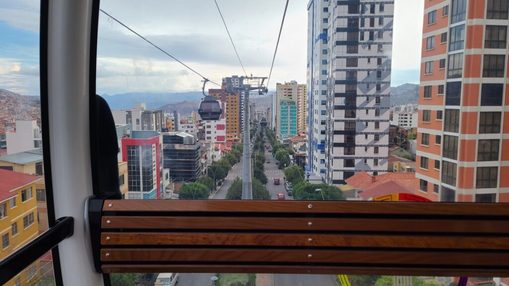 Cable car over tree-lined street below in La Paz, Bolivia