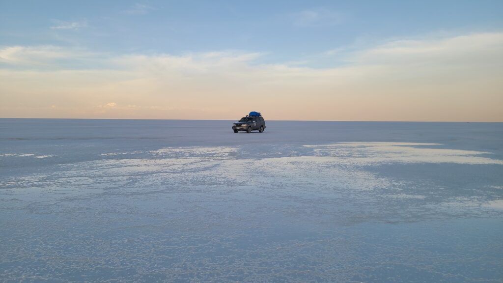 Jeep on the white salt flats of Uyuni, Bolivia