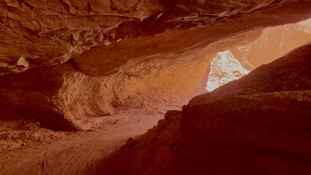 Red rock tunnel to cycle through near San Pedro de Atacama